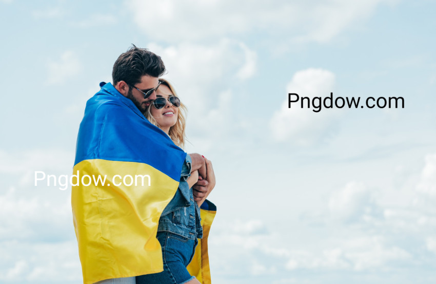 attractive woman and handsome man smiling and holding ukrainian flag