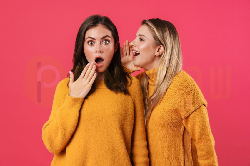 Image of Beautiful Woman Whispering Secret to Her Shocked Friend