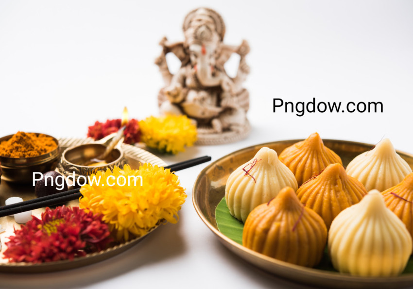 Indian Festival   Indian sweet food called Modak offered as prasad or prashad or chadhava over green leaf to Lord Ganesha on Ganesh Chaturthi with puja or pooja thali and decorated with flowers