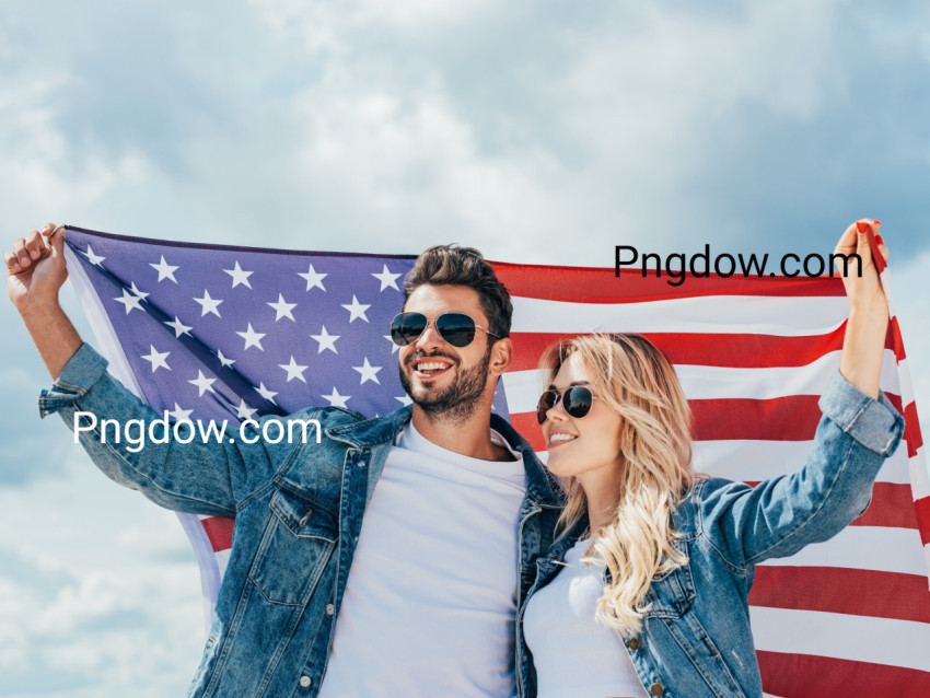 attractive woman and handsome man smiling and holding american flag